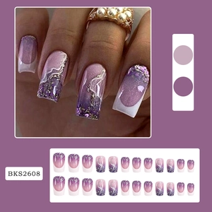 Detail of purple gradient press-on nails with silver marble patterns and white french tips