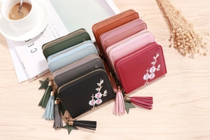 Detailed macro view of embroidered PU leather wallets with elegant floral patterns
