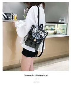 Detail showing transparent PVC backpack with black inner pouch and golden metal clasp