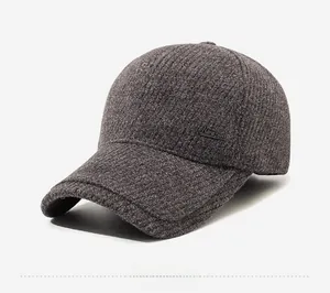 Close-up of thick tweed texture and Narason metal emblem on grey winter baseball cap