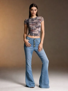 Detail of high waisted flared jeans with button fly and colorful floral mesh top