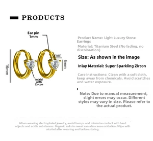 Detail view of 16mm gold titanium steel hoop earrings with heart-shaped zircon pendants