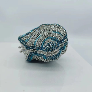 Macro shot of luxury hollow frog-shaped evening clutch bag with blue and silver crystals