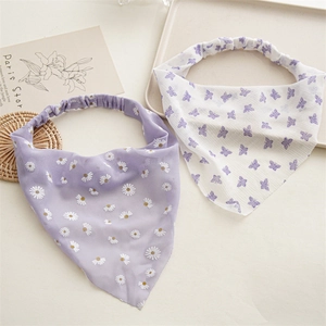 Detailed close-up of chiffon floral hair scarf and butterfly print elastic scrunchie