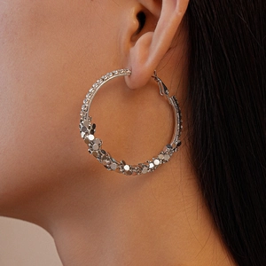 Sparkling silver geometric circular hoop earrings with diamond-encrusted metallic texture
