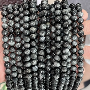 Macro shot of natural eagle eye stone round beads with polished fiber texture