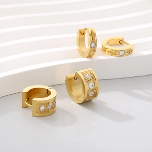 Gold huggie hoop earrings with star and geometric engravings and inlaid zircon stones