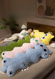 Close-up of soft cat plush pillows in multiple colors with cute paw embroidery detail
