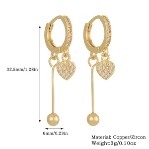 Detailed view of long gold drop earrings with dimensions 32.5mm by 6mm and weight 3g