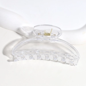 Close-up of a clear plastic semi-circular hair claw clip on a clean white background