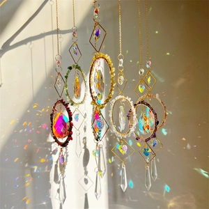 Detail of hanging crystal suncatchers with metal hoops and colorful crushed stones