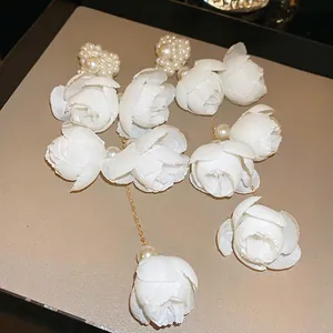 Elegant long tassel earrings with white 3D silk flowers and delicate pearls detail