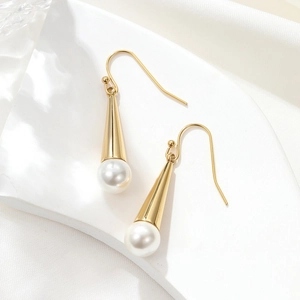 Elegant gold drop earrings with white pearls and sleek metal tubes on white background
