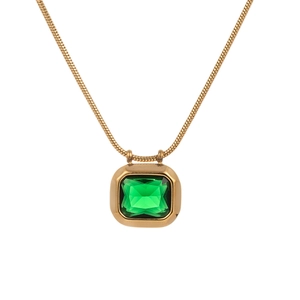 Close-up of a gold snake chain necklace featuring a square emerald green zircon pendant