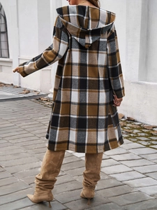 Full back view of a long hooded plaid coat in brown and black on an outdoor walkway