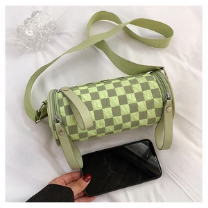 Macro shot of a cylinder checkered crossbody bag showing seersucker texture and size scale