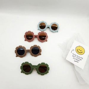 Kids flower-shaped sunglasses in four matte retro colors on a white background