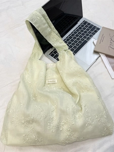 Light yellow canvas tote bag with white flower embroidery and stylish wide shoulder straps