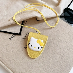 Detail of yellow lychee leather card holder featuring 3D Hello Kitty and long lanyard