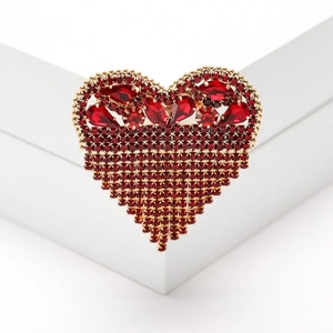 Elegant heart-shaped tassel brooch with red rhinestones in a gold alloy setting