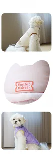 Detailed view of corduroy pet vest fabric and Smile ticket label on pink quilted dog jacket