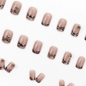 French zebra pattern press-on nails in nude pink with glitter and rhinestone accents