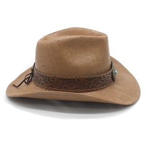 Detail of brown straw cowboy hat with vintage leather band and turquoise stone accent