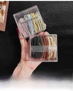 Close-up of high-elastic spiral hair ties in macaron colors and plastic box storage