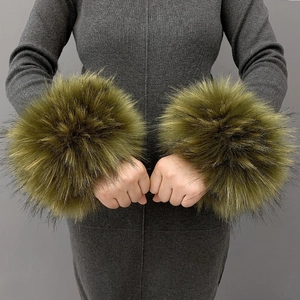 Detail of soft faux fur wrist cuffs in dark green finish on a model's wrist