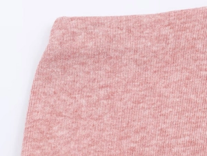 Gros plan sur la texture du tricot rose avec des coutures de qualité sur cet ensemble