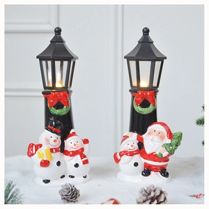 Macro view of glowing LED Christmas snowman and Santa Claus street lamp decorations