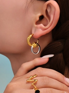 Detail von 18k vergoldeten Knotohrringen und Wellenring am Modell mit poliertem Finish
