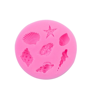 Pink round silicone mold with various starfish and seashell patterns for DIY baking