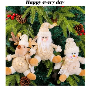 Close-up of Santa Claus, reindeer, and snowman ornaments in gold and cream tones