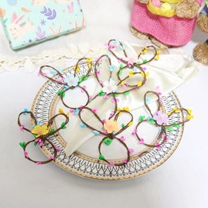 Easter bunny napkin rings with woven ears and colorful berries for garden party decor