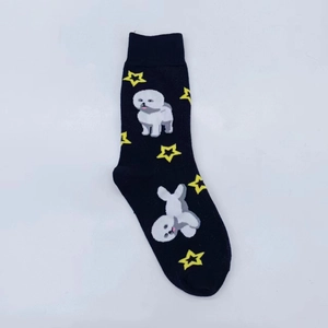 Detail of black cotton socks featuring a white Bichon dog and yellow star pattern