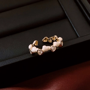 Detail of 14K gold plated ring featuring white enamel hearts and sparkling heart zircons
