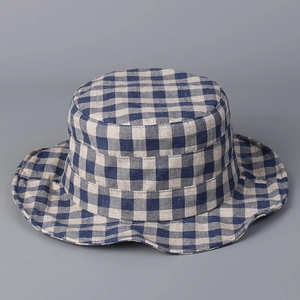 Detail of blue and white checkered linen sun hat with a wavy brim and flat top