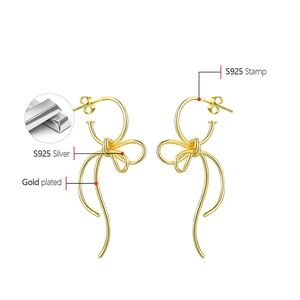 Macro detail of S925 sterling silver stamp on gold plated bow earrings for women