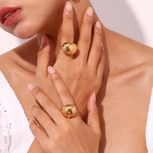 Macro detail of 18K gold plated teardrop ring with micro-pave stones on female model