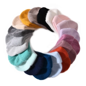 Detailed overhead view of plush rabbit fur knit beanies in various vibrant colors