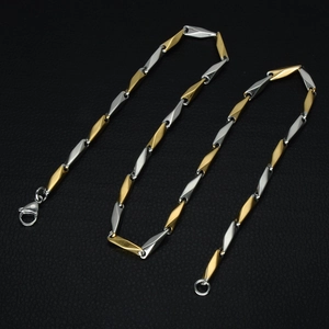 Polished two-tone gold and silver stainless steel link chain with a secure lobster clasp