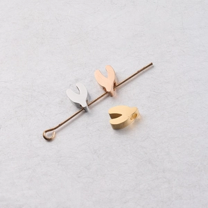 Detailed macro view of heart-shaped stainless steel beads in silver, rose gold, and gold