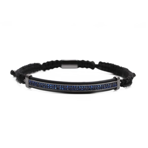 Close-up of black braided cord bracelet with dark blue zircon micro-paving on metal insert