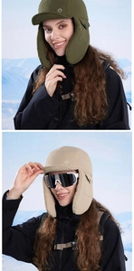 Detail of windproof winter trapper hat with ear flaps in olive green and beige colors