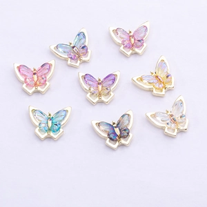 Detailed view of colorful alloy butterfly nail charms with iridescent resin wings