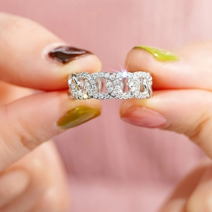 Macro detail of silver Cuban chain ring with micro-pave cubic zirconia crystals
