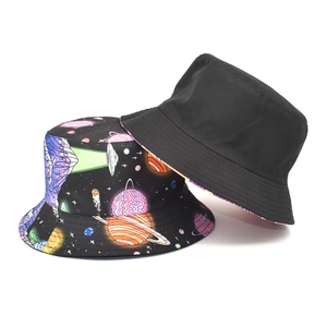 Detail of double-sided bucket hat featuring black space print and classic plain black side