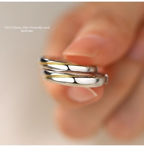 Macro shot of S925 sterling silver couple rings with polished gold stripe detailing