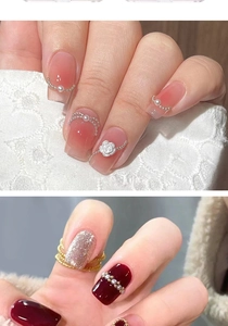 Detail of pink gradient and dark red manicures with decorative metal beads and pearls